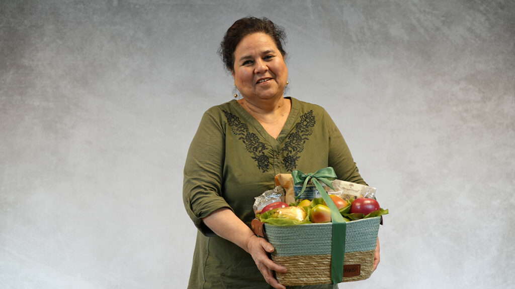 Packing baskets with a woman holding a Harry & David basket.