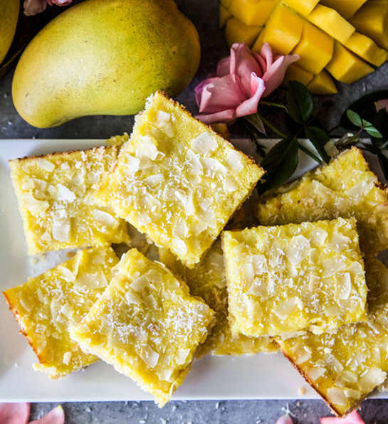 Mango coconut cookie bars stacked on a plate