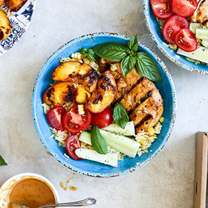 Bowl of grilled peaches chicken rice and other veg