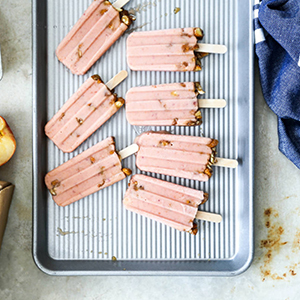 Plum nectarine popsicles on a baking sheet