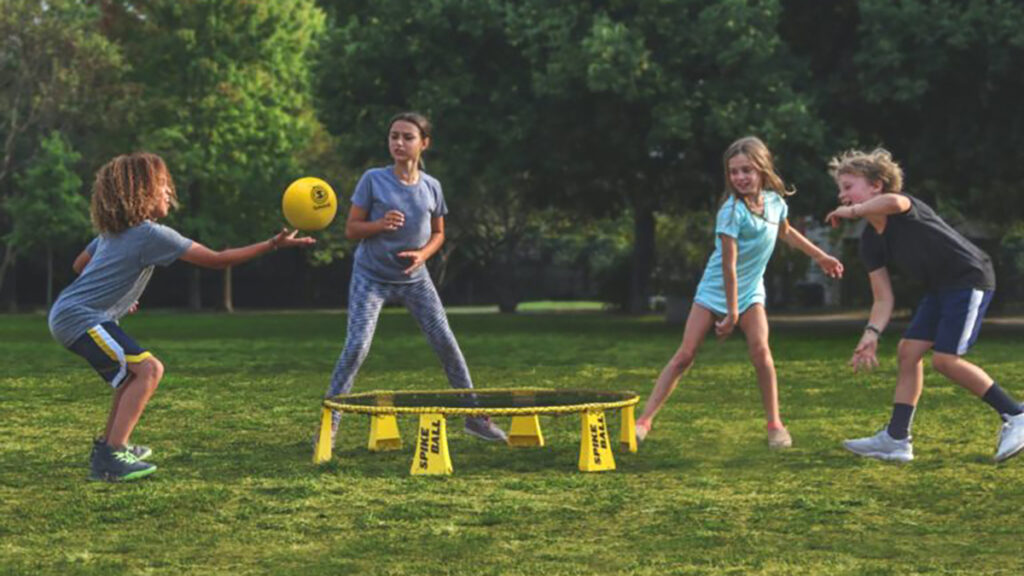 Kids playing a ball game in the summer sunshine.