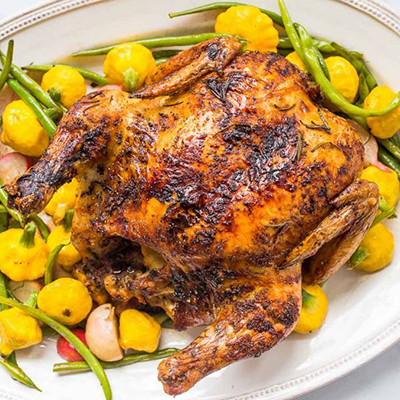 Roast chicken and vegetables on a plate for New Years dinner