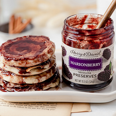 Breakfast for dinner with a plate of marionberry pancakes next to a jar of preserves