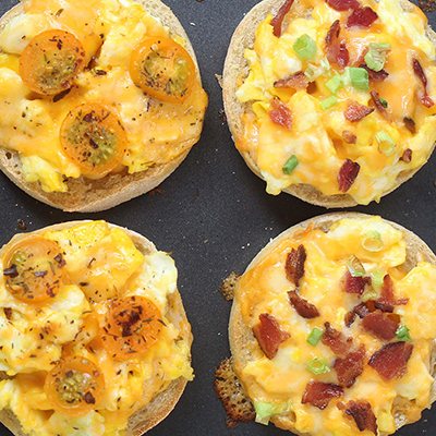 Breakfast for dinner with English muffins topped with eggs