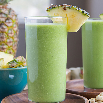 Pineapple recipes with a green smoothie in a glass