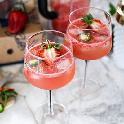 Two strawberry cocktails on a marble counter