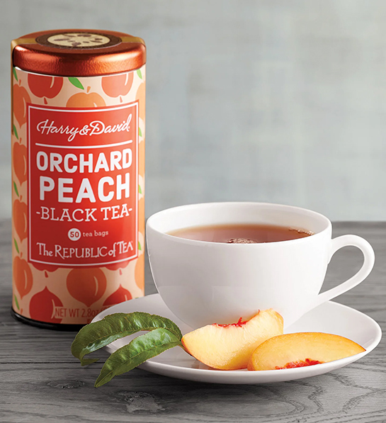 Tin of peach tea next to a cup of tea for a tea party