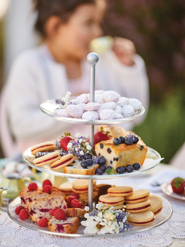 Tea party treats on a tiered tray.