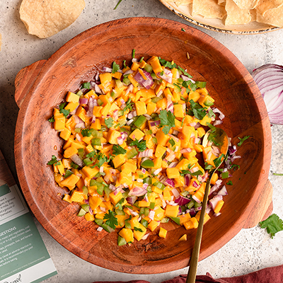 Mango salsa in a wooden bowl