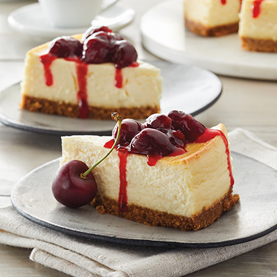 Ways to use fruit with two plates of cheesecake topped with cherrie coulis